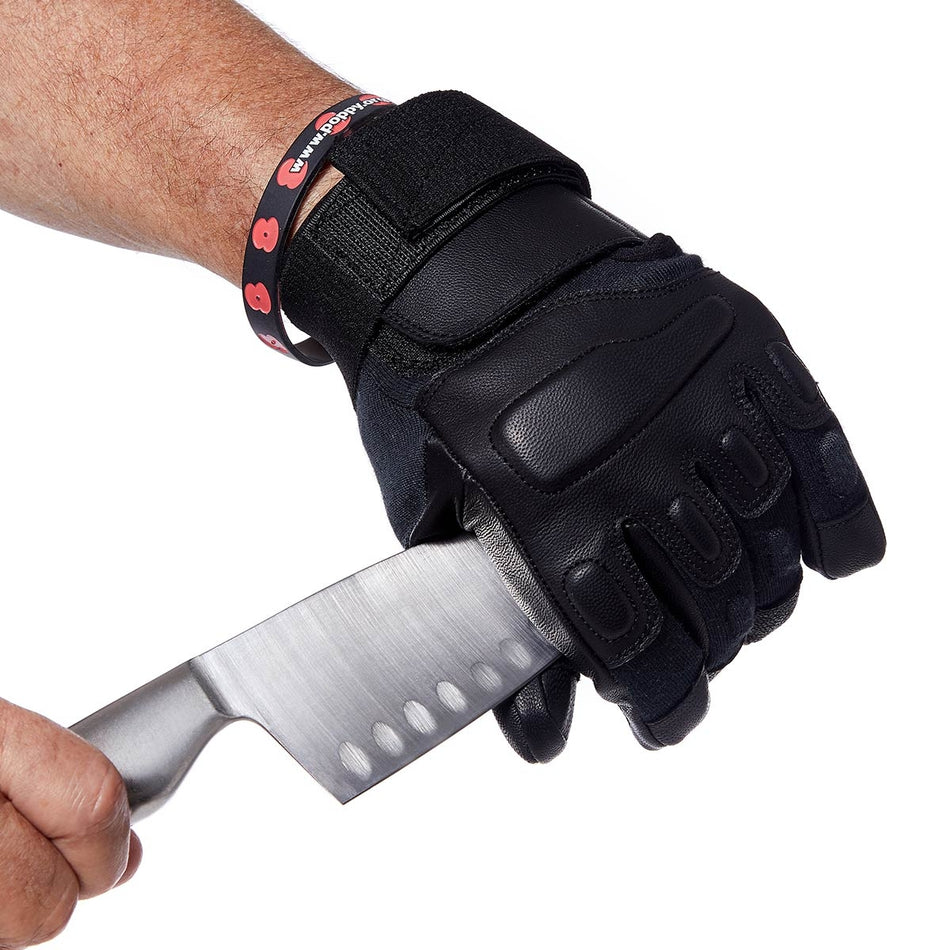 Black tactical glove holding a knife on a white background